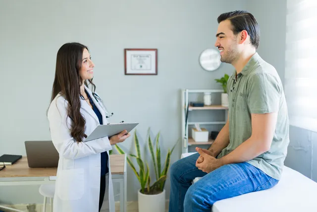Doctor consulting a smiling patient in a bright clinic