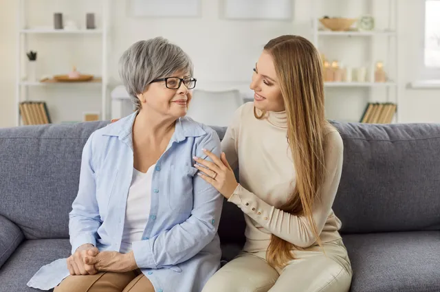 Adult daughter caring for her elderly mother at home