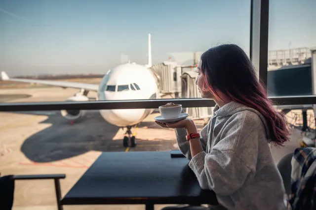 Passenger with a coffee in an airport lounge